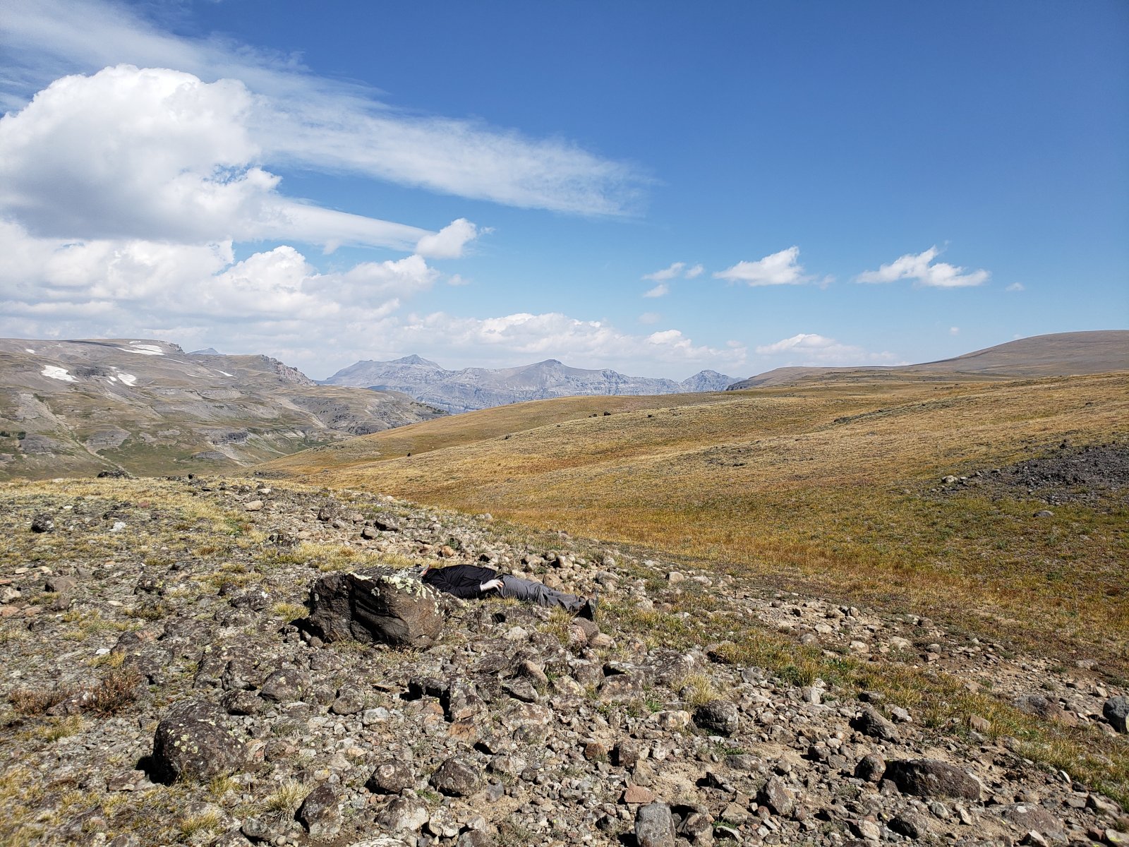 My brother taking a quick power nap at a crest in the Divide.