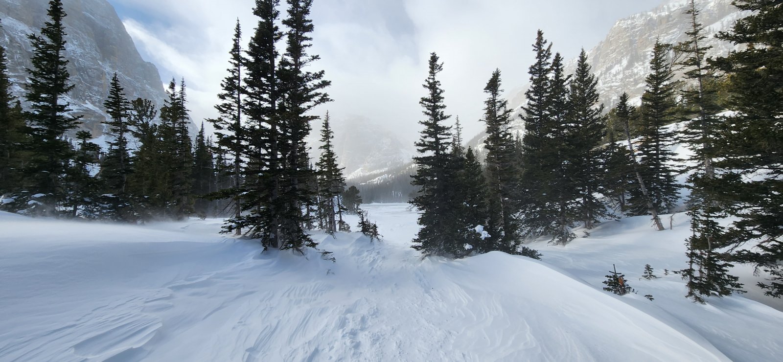 Approaching Loch Vale where the wind really began to pick up. The 
windblown snow obscured the track in places, but still easy enough to 
follow.
