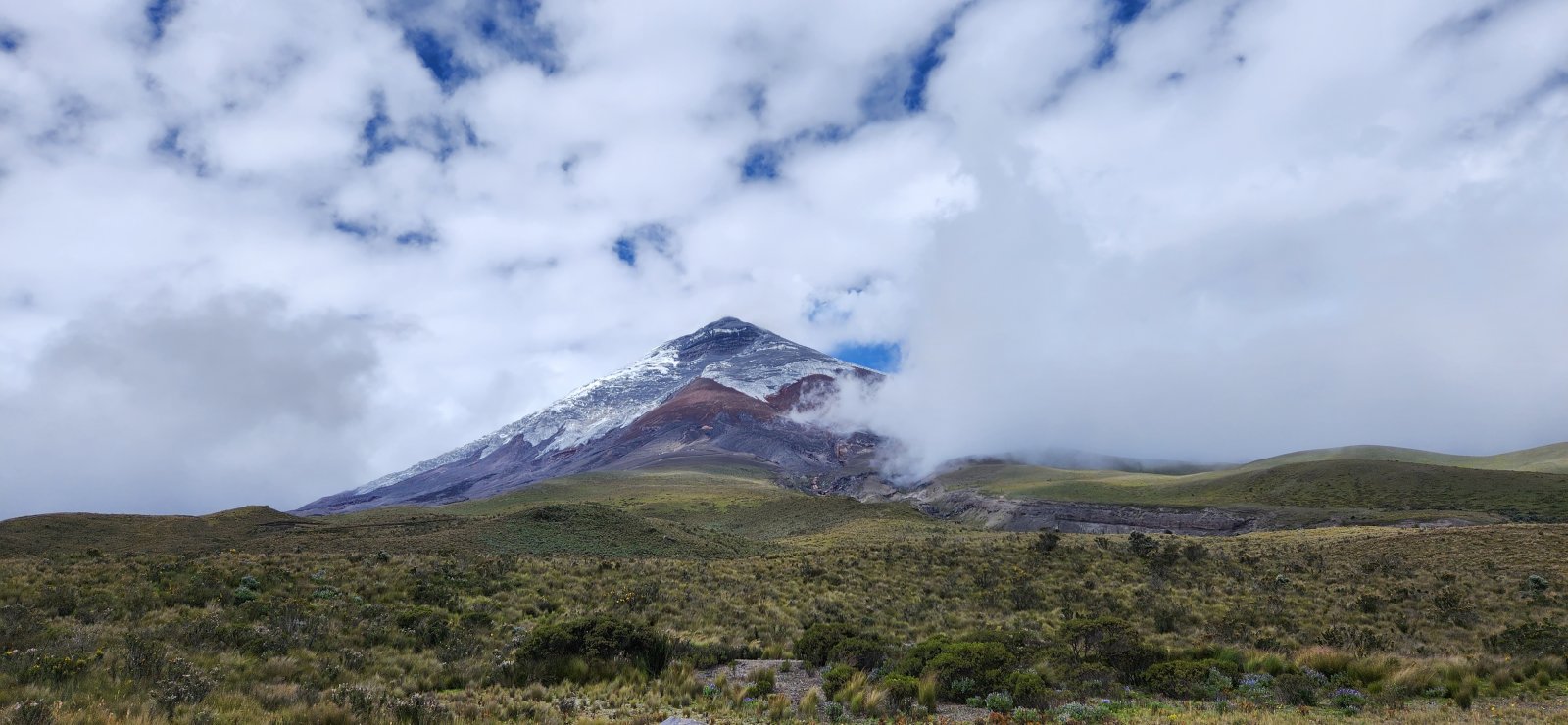 Cotopaxi coming into clearer view - the grey near the summit is all ash on top of the glacier.