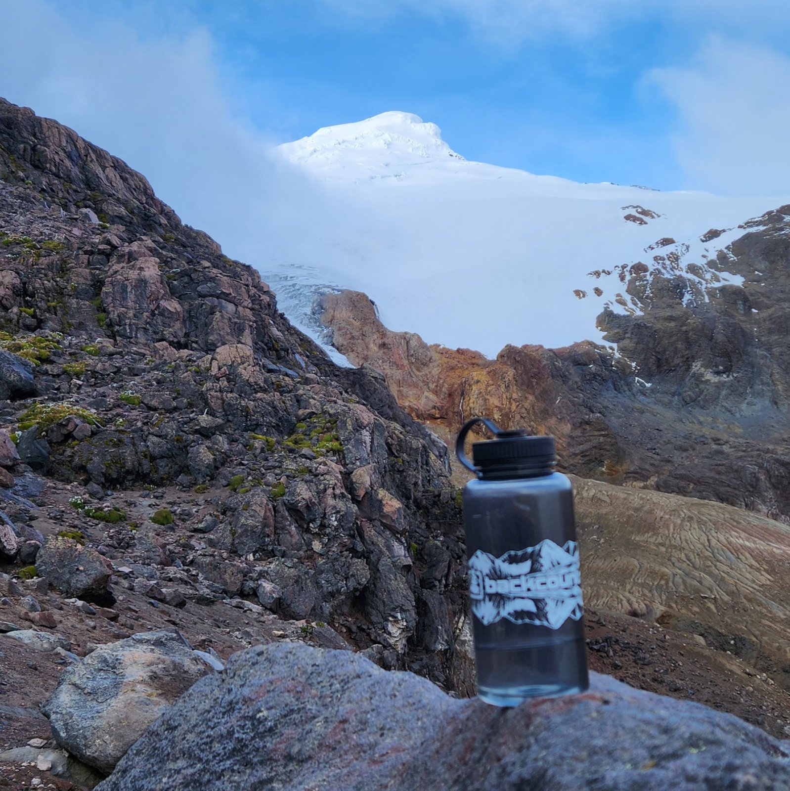 The summit peeked out briefly the night before the climb - really got me
 hyped. (I don't use Nalgenes on backpacking trips, so I took this 
opportunity to showcase my BCP swag.)