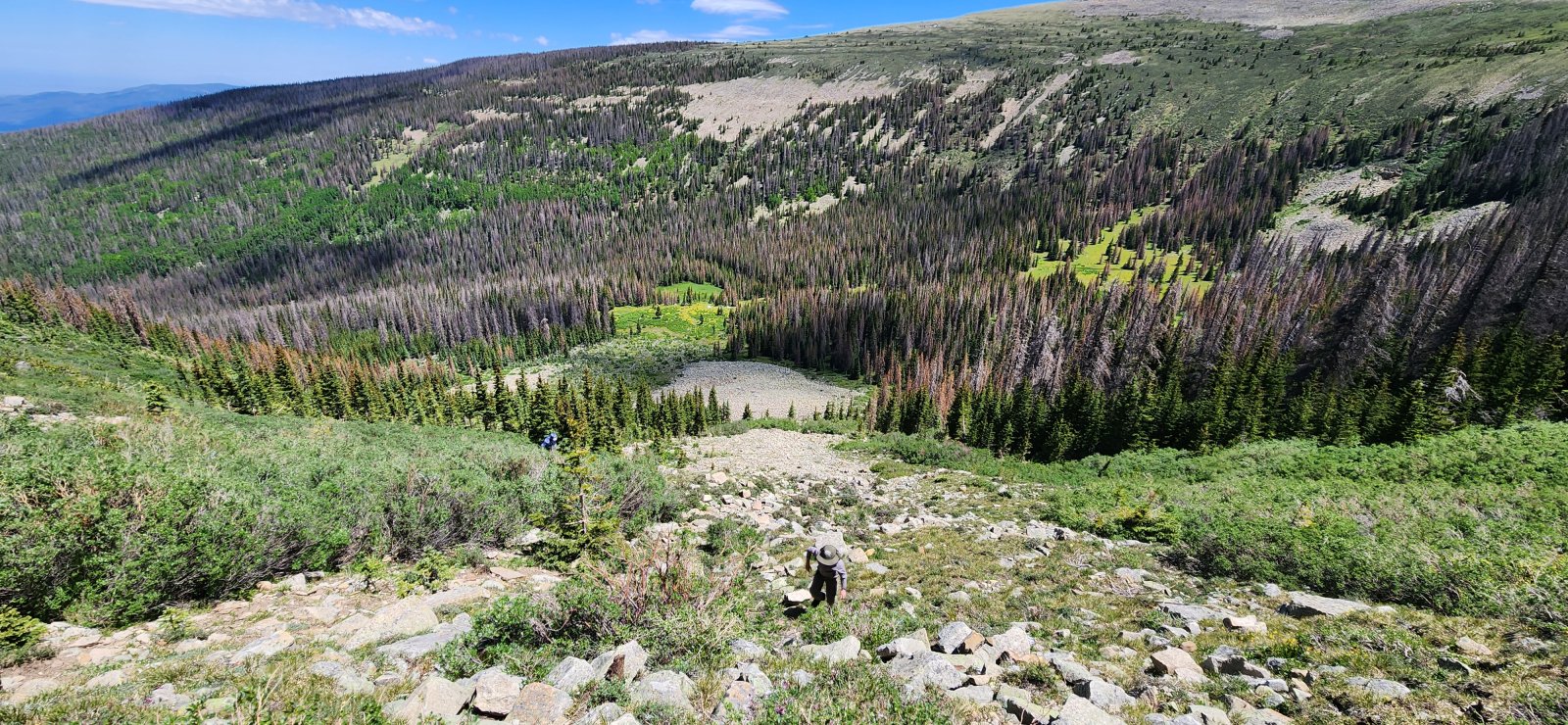My son making his way up - our tents barely visible in the distance.